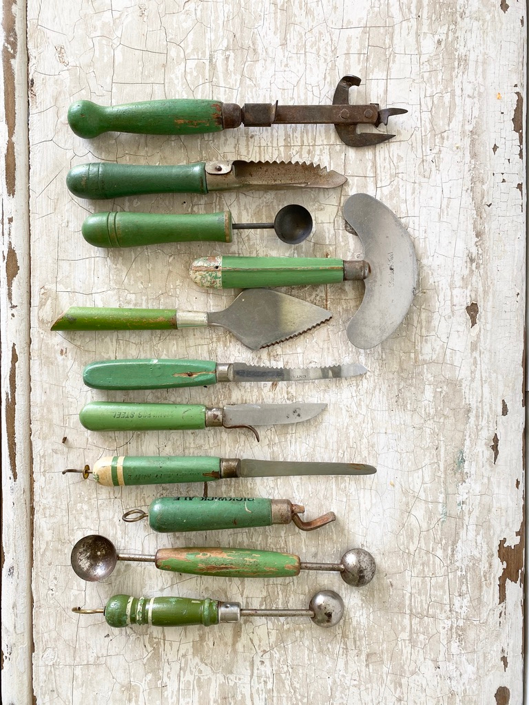 A collection of vintage green kitchen utensils