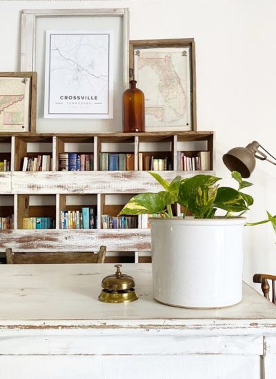 A pathos plant tucked inside a vintage stoneware crock