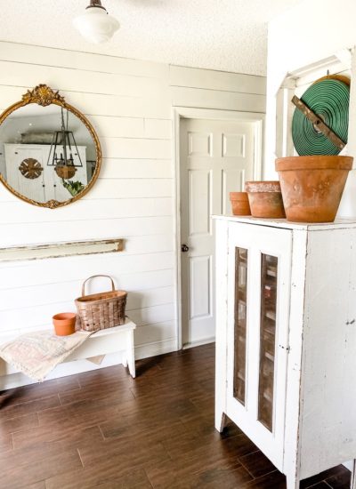 A collection of weathered terra cotta pots in the entryway