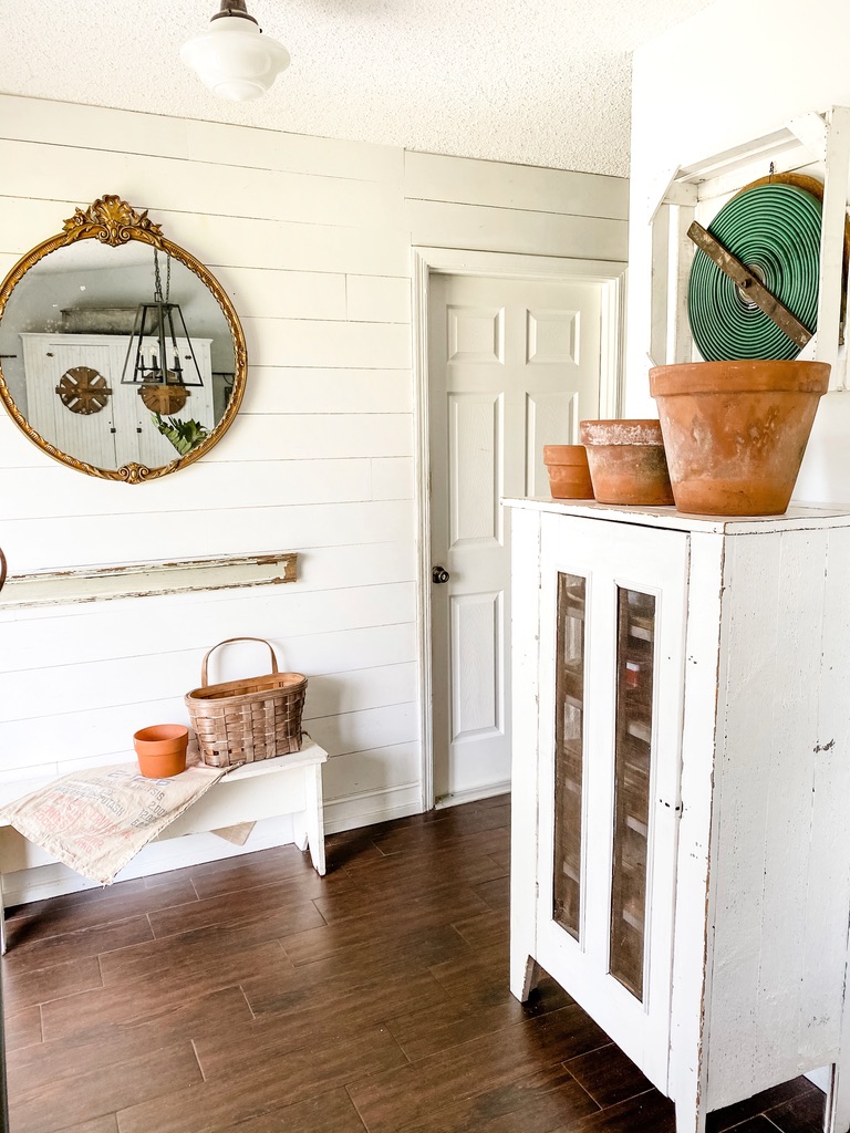 A collection of weathered terra cotta pots in the entryway