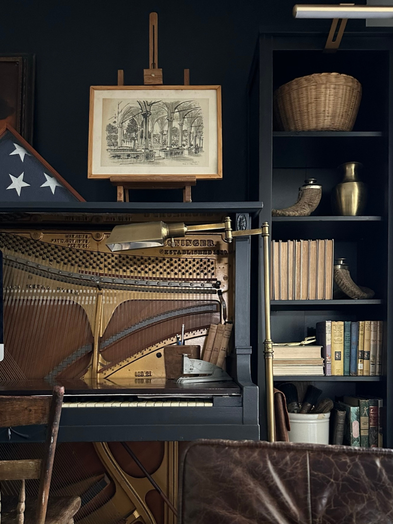 A stunning view of our black office nook featuring a vintage brass floor lamp and a new cordless LED bookshelf light from Amazon.