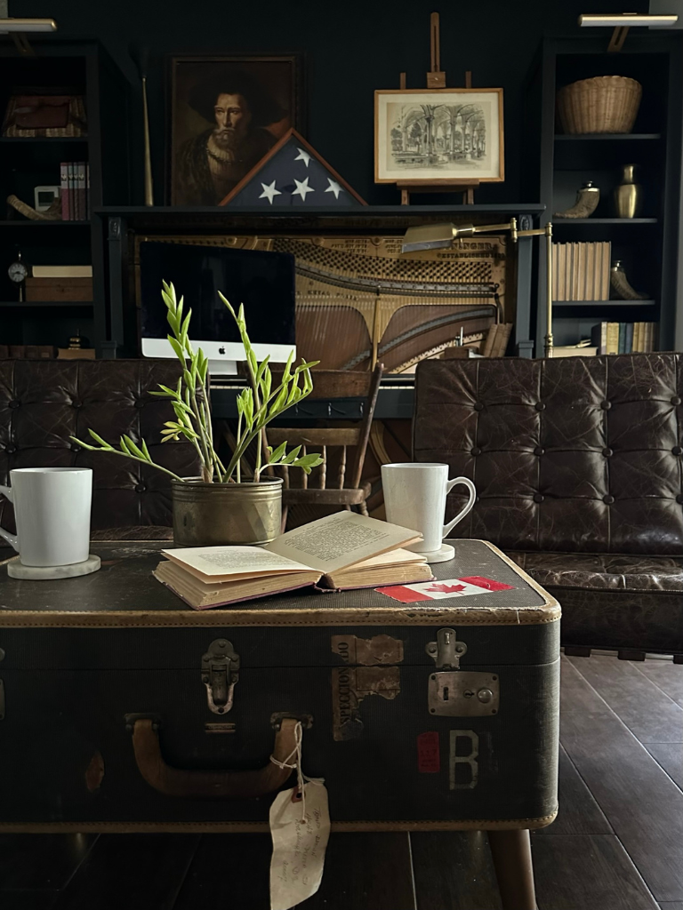 A view of our office featuring a vintage suitcase repurposed as a coffee table in front of a pair of Barcelona chairs.